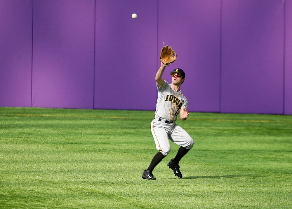 Iowa Hawkeyes outfielder Justin Jenkins (6) pulls in a fly ball for an out during the fourth inning of their CambriaCollegeClassic game at U.S. Bank Stadium in Minneapolis, Minn. on Friday, February 28, 2020. (Stephen Mally/hawkeyesports.com)