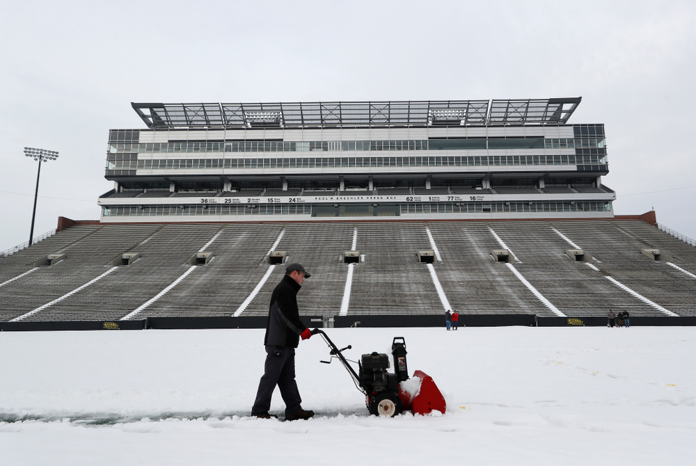 Members of the Iowa Athletics Turf Management staff create the #SnowWave for kids in the Stead Family Children's Hospital Thursday, February
