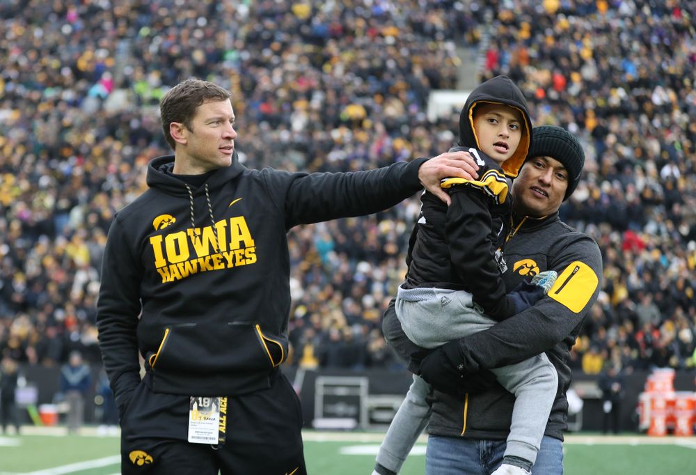 Honorary Captain Jason Baker and Kid Captain Mason Gonzalez against the Northwestern Wildcats Saturday, November 10, 2018 at Kinnick Stadium. (Brian Ray/hawkeyesports.com)