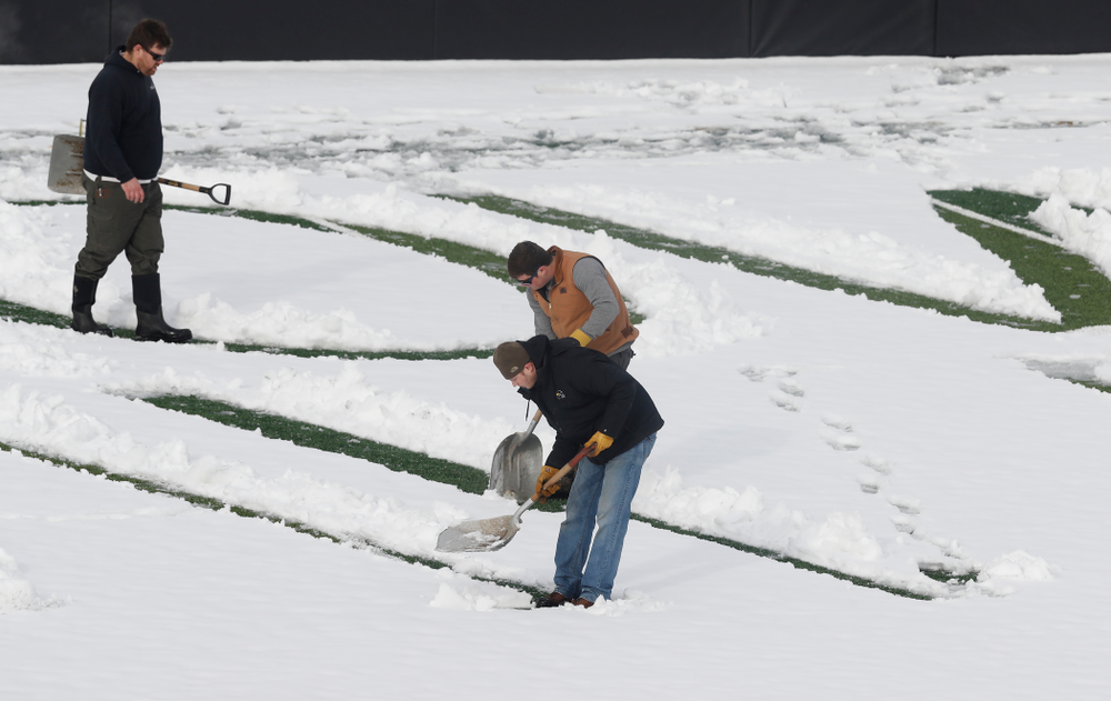 Members of the Iowa Athletics Turf Management staff create the #SnowWave for kids in the Stead Family Children's Hospital Thursday, February