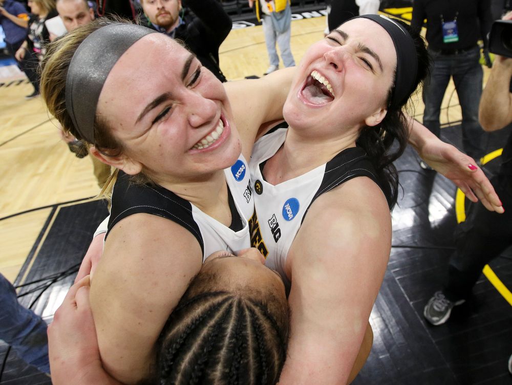 Iowa Hawkeyes forward Hannah Stewart (21), guard Tania Davis (11), and center Megan Gustafson (10) hug after winning their second round game in the 2019 NCAA Women's Basketball Tournament at Carver Hawkeye Arena in Iowa City on Sunday, Mar. 24, 2019. (Stephen Mally for hawkeyesports.com)
