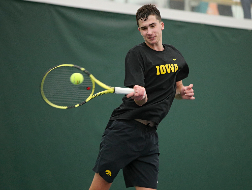Iowa’s Matt Clegg hits a shot during his match against Marquette at the Hawkeye Tennis and Recreation Complex in Iowa City on Saturday, January 25, 2020. (Stephen Mally/hawkeyesports.com)