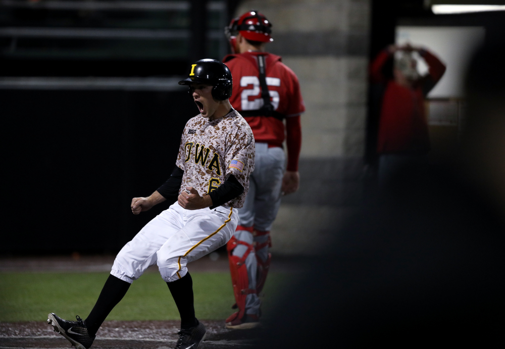 Iowa Hawkeyes outfielder Justin Jenkins (6) scores the game winning run in the bottom of the 9th against the Nebraska Cornhuskers on Military Appreciation Night Friday, April 19, 2019 at Duane Banks Field. (Brian Ray/hawkeyesports.com)