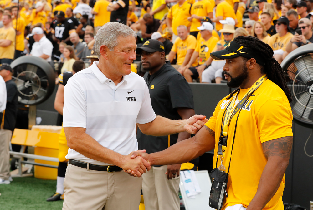 Iowa Hawkeyes head coach Kirk Ferentz talks with former Hawkeyes Bob Sanders against the Norther Illinois Huskies Saturday, September 1, 2018 . (Brian Ray/hawkeyesports.com)