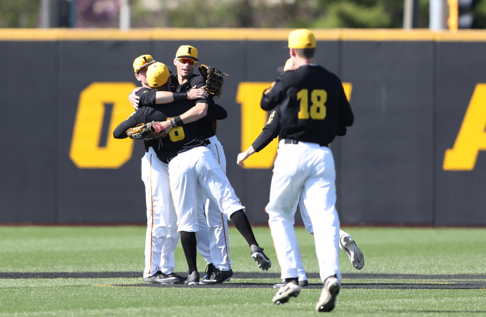 Iowa Hawkeyes Chris Whelan (28), outfielder Ben Norman (9), and outfielder Justin Jenkins (6) hug after winning game two against UC Irvine Saturday, May 4, 2019 at Duane Banks Field. (Brian Ray/hawkeyesports.com)