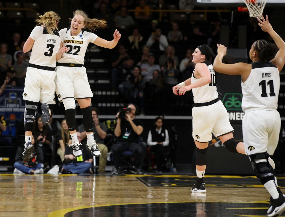 Iowa Hawkeyes guard Makenzie Meyer (3) and guard Kathleen Doyle (22) celebrate after Meyer's 3-pointer as forward Megan Gustafson (10) and guard Tania Davis (11) join during the first round of the 2019 NCAA Women's Basketball Tournament at Carver Hawkeye Arena in Iowa City on Friday, Mar. 22, 2019. (Stephen Mally for hawkeyesports.com)