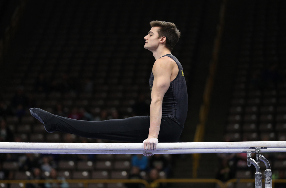 Iowa's Mitch Mandozzi competes on the parallel bars against the Ohio State Buckeyes Saturday, March 16, 2019 at Carver-Hawkeye Arena. (Brian Ray/hawkeyesports.com)