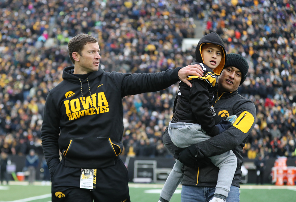 Honorary Captain Jason Baker and Kid Captain Mason Gonzalez against the Northwestern Wildcats Saturday, November 10, 2018 at Kinnick Stadium. (Brian Ray/hawkeyesports.com)