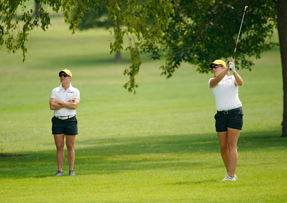 Iowa’s Sarah Overton (right) watches her shot as head coach Megan Menzel looks on during their dual against Northern Iowa at Pheasant Ridge Golf Course in Cedar Falls on Monday, Sep 2, 2019. (Stephen Mally/hawkeyesports.com)