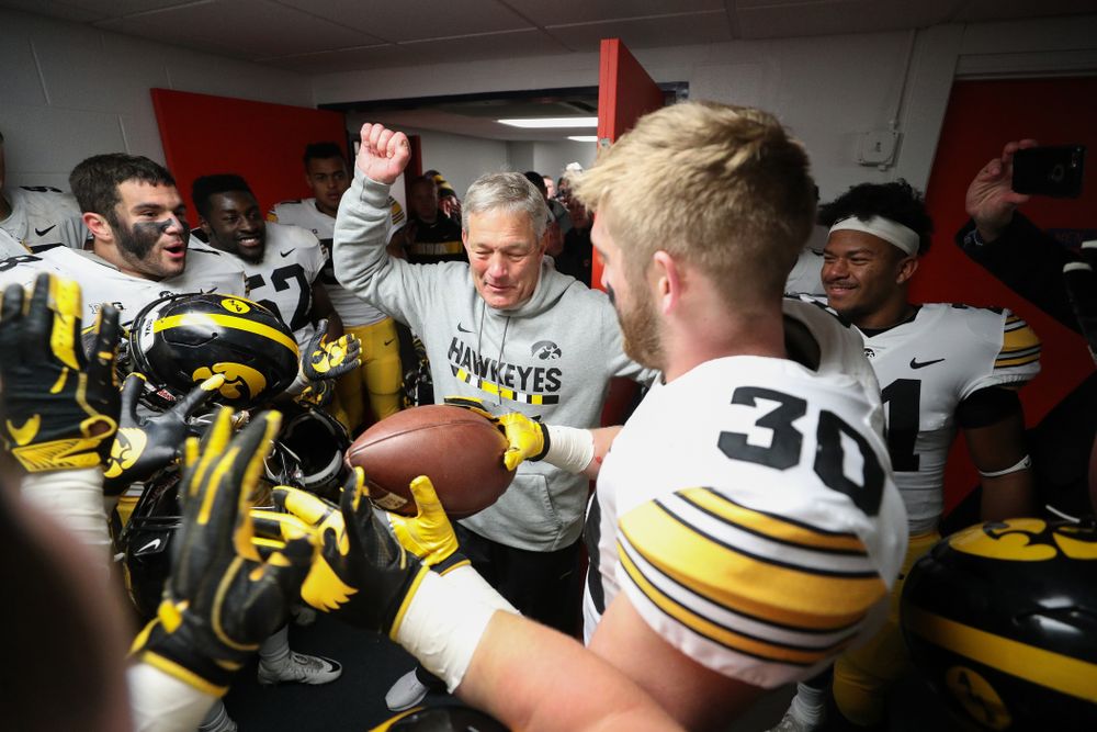 Iowa Hawkeyes defensive back Jake Gervase (30) presents the game ball to head coach Kirk Ferentz to commemorate his 150th win as head coach fo the Iowa Hawkeyes following their 63-0 win over the Illinois Fighting Illini Saturday, November 17, 2018 at Memorial Stadium in Champaign, Ill. (Brian Ray/hawkeyesports.com)