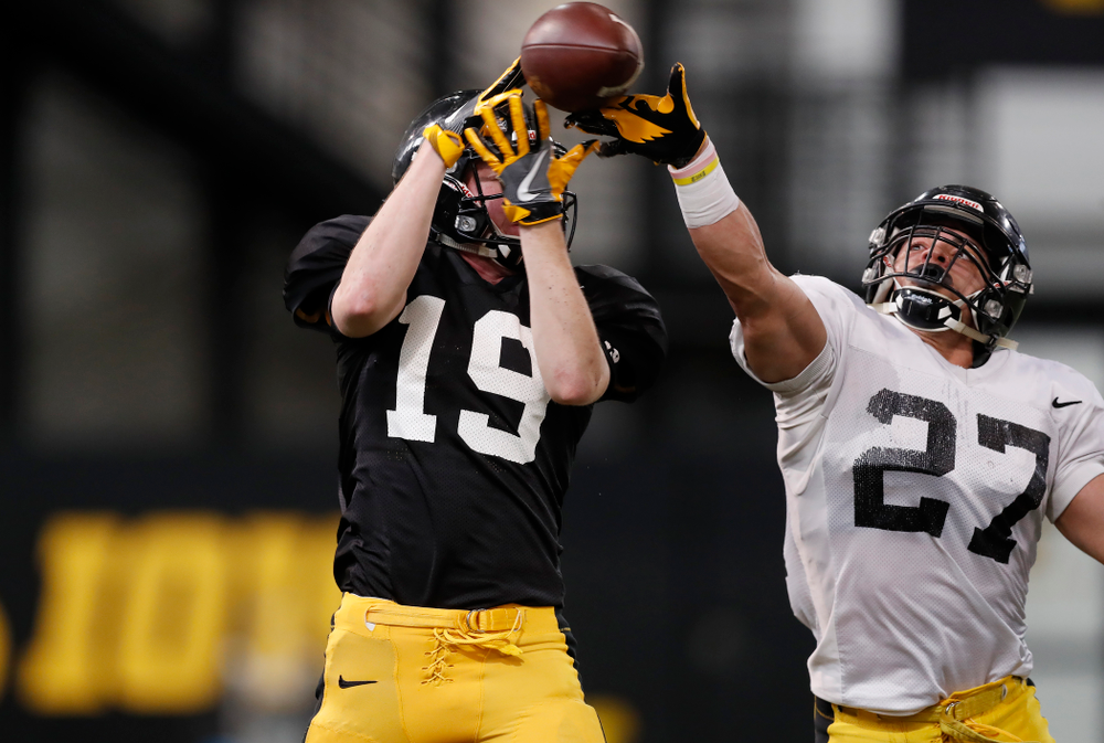 Iowa Hawkeyes wide receiver Max Cooper (19) and defensive back Amani Hooker (27) during spring practice Wednesday, March 28, 2018 at the Hansen Football Performance Center. (Brian Ray/hawkeyesports.com)