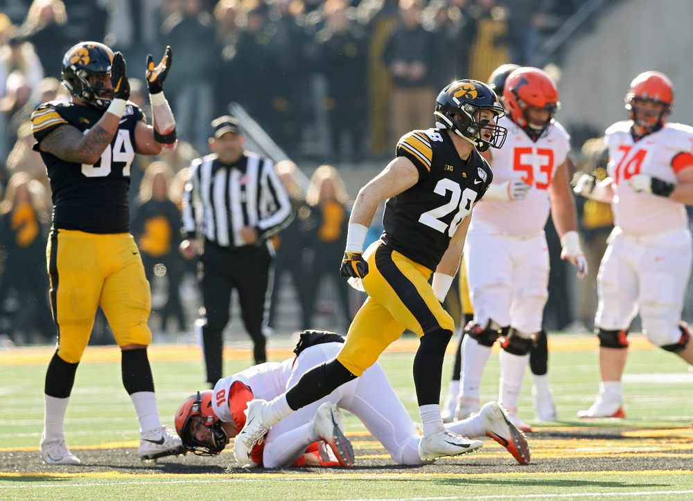 Iowa Hawkeyes defensive back Jack Koerner (28) celebrates after Illinois Fighting Illini quarterback Brandon Peters (18) was sacked during the second quarter of their game at Kinnick Stadium in Iowa City on Saturday, Nov 23, 2019. (Stephen Mally/hawkeyesports.com)