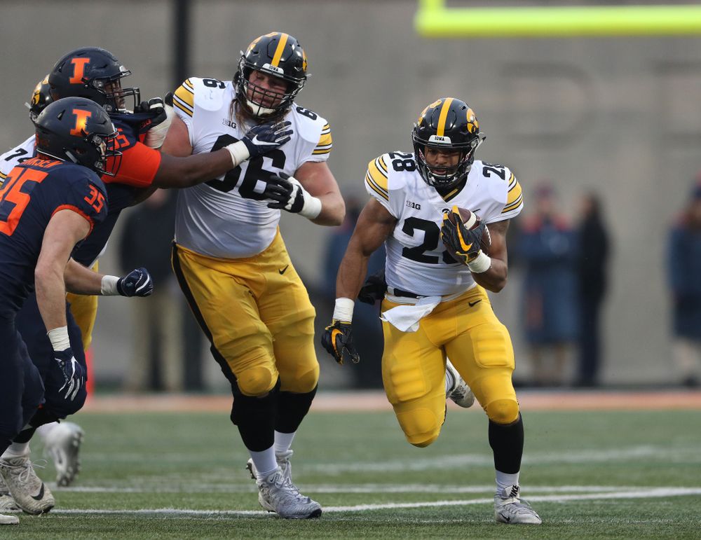 Iowa Hawkeyes running back Toren Young (28) runs behind offensive lineman Levi Paulsen (66) against the Illinois Fighting Illini Saturday, November 17, 2018 at Memorial Stadium in Champaign, Ill. (Brian Ray/hawkeyesports.com)