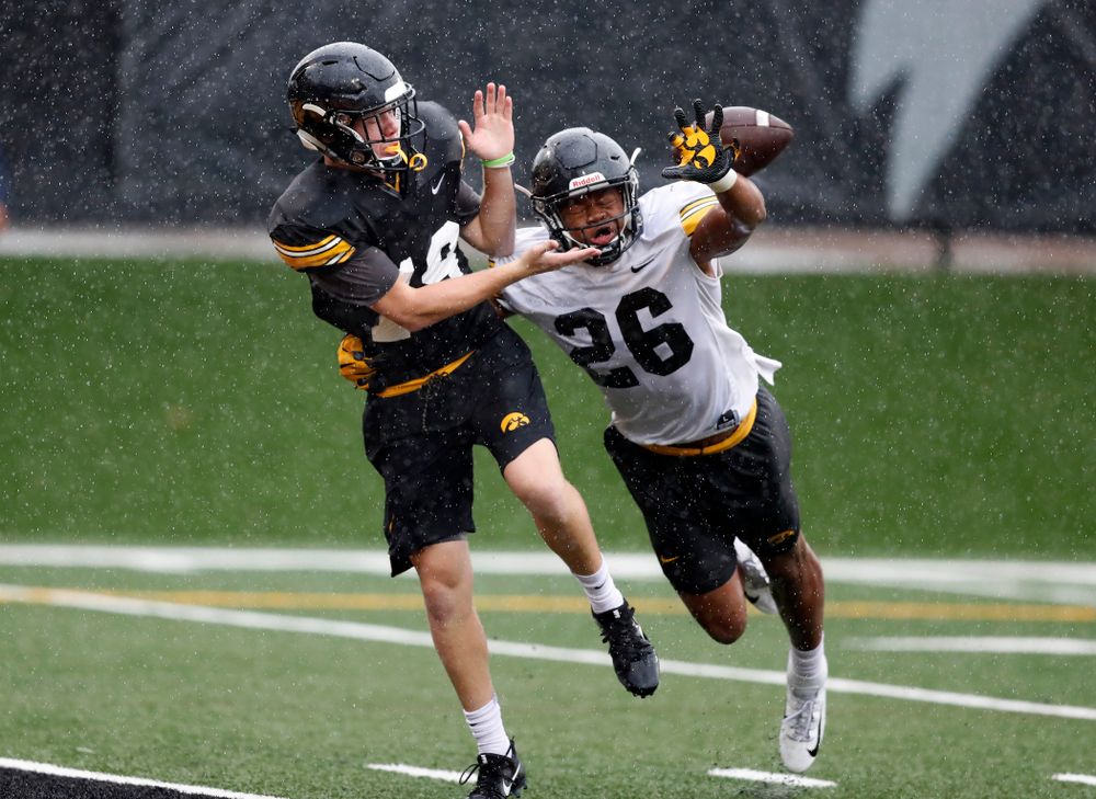 Iowa Hawkeyes wide receiver Max Cooper (19) and defensive back Kaevon Merriweather (26) during camp practice No. 15 Monday, August 20, 2018 at the Hansen Football Performance Center. (Brian Ray/hawkeyesports.com)