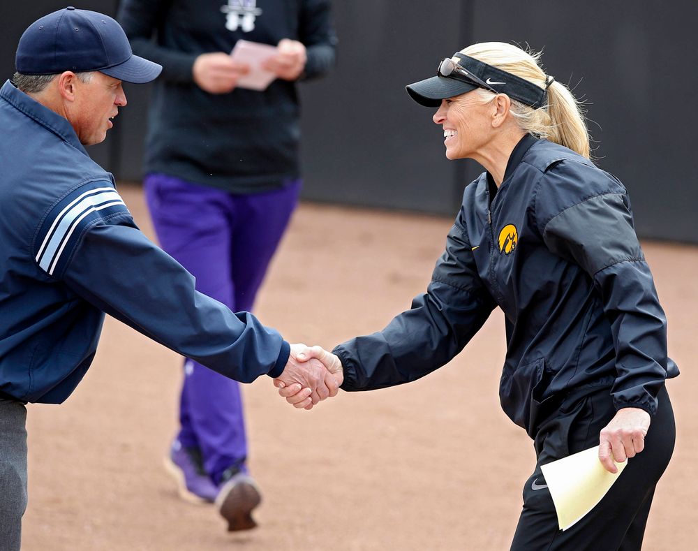 Iowa Hawkeyes head coach Renee Gillispie shakes hands with an umpire before their Big Ten Conference softball game at Pearl Field in Iowa City on Friday, Mar. 29, 2019. (Stephen Mally/hawkeyesports.com)