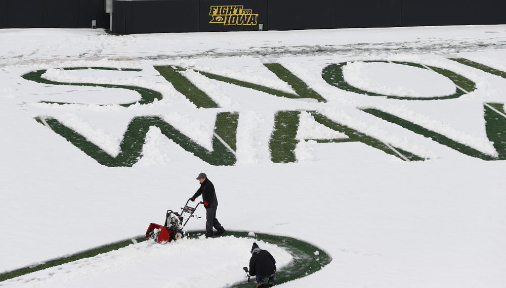 Members of the Iowa Athletics Turf Management staff create the #SnowWave for kids in the Stead Family Children's Hospital Thursday, February