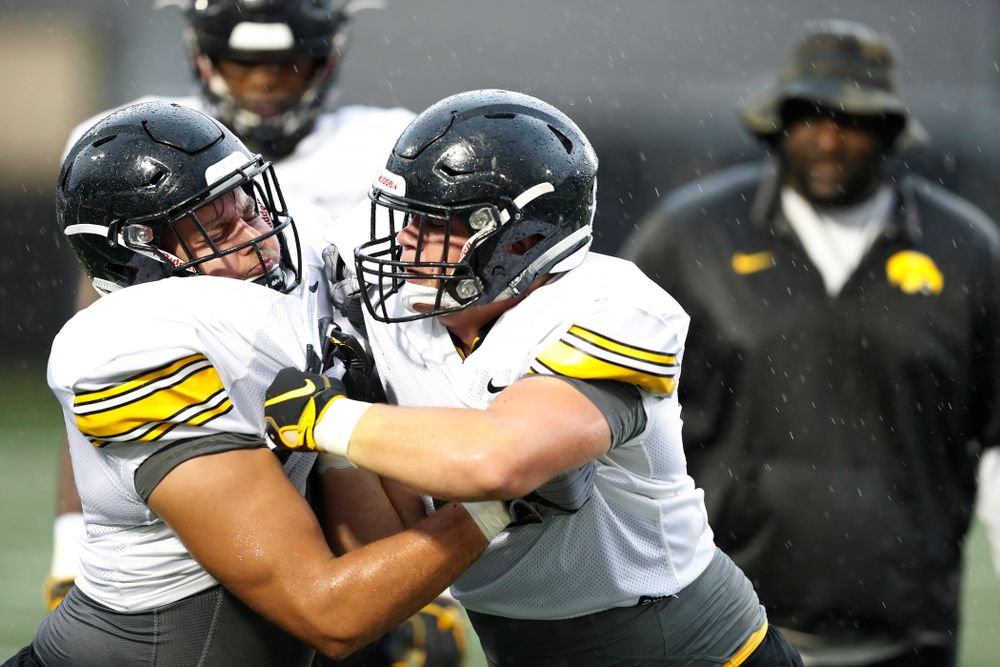 Iowa Hawkeyes defensive end Sam Brincks (90) and defensive lineman Tyler Linderbaum (65) during camp practice No. 15 Monday, August 20, 2018 at the Hansen Football Performance Center. (Brian Ray/hawkeyesports.com)