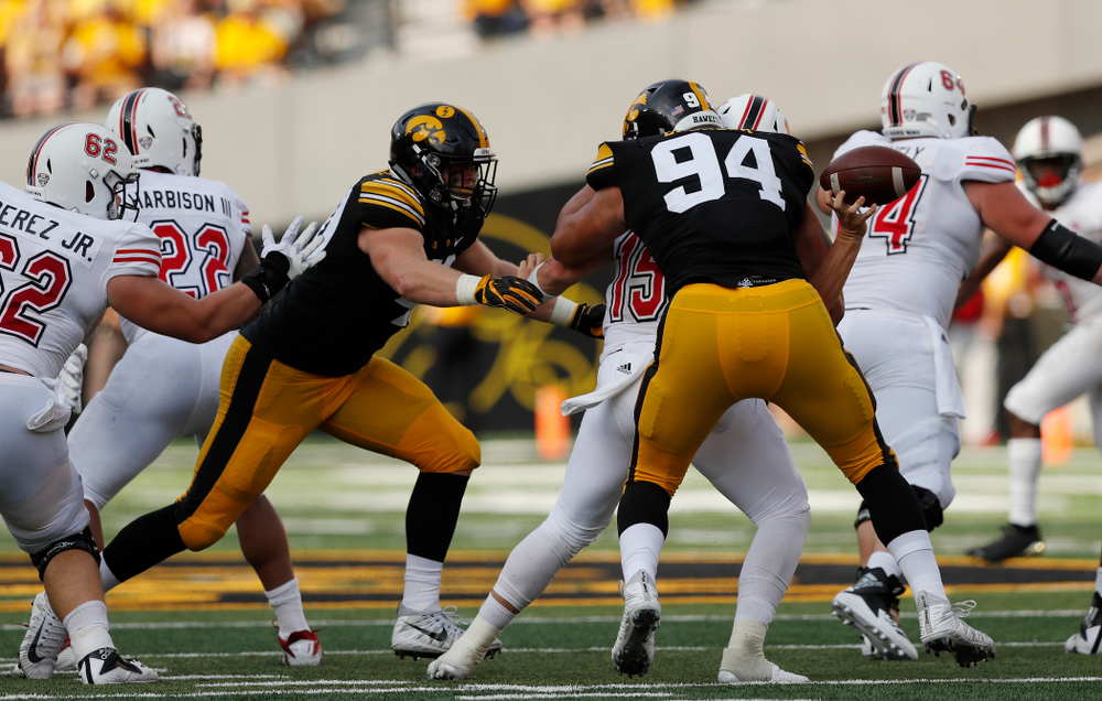 Iowa Hawkeyes defensive end A.J. Epenesa (94) strips Northern Illinois Huskies quarterback Marcus Childers (15) Saturday, September 1, 2018 at Kinnick Stadium. (Brian Ray/hawkeyesports.com)