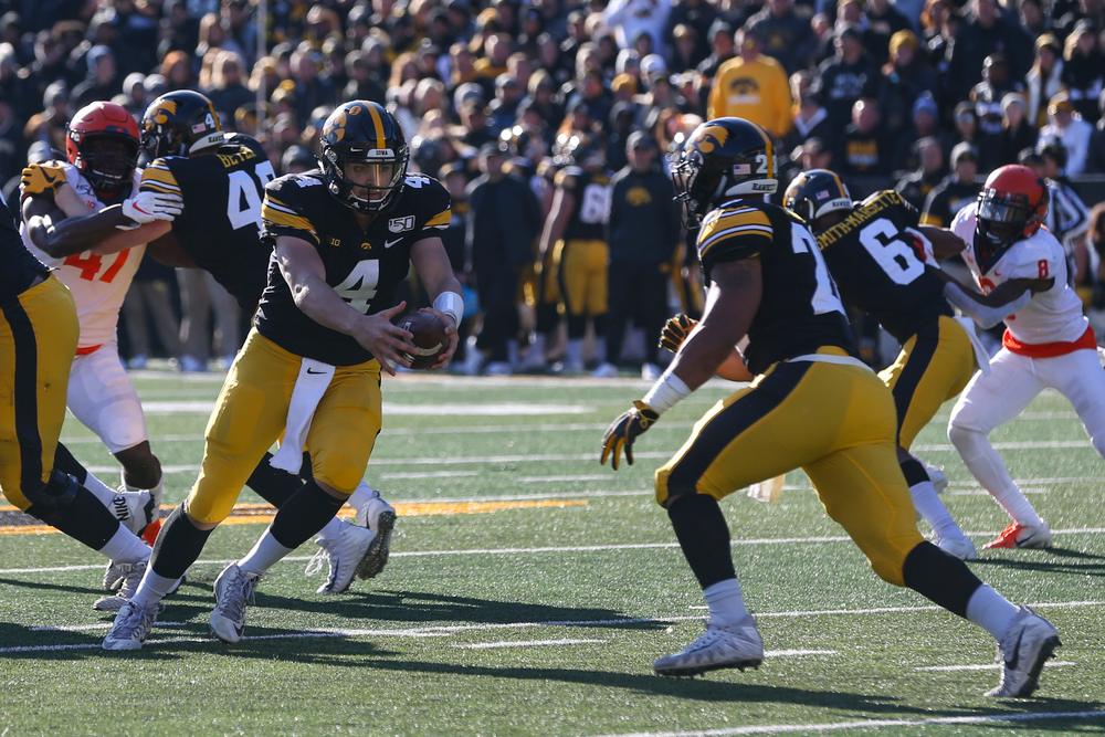 Iowa Hawkeyes quarterback Nate Stanley (4) and Iowa Hawkeyes running back Toren Young (28) during Iowa football vs Illinois on Saturday, November 23, 2019 at Kinnick Stadium. (Lily Smith/hawkeyesports.com)