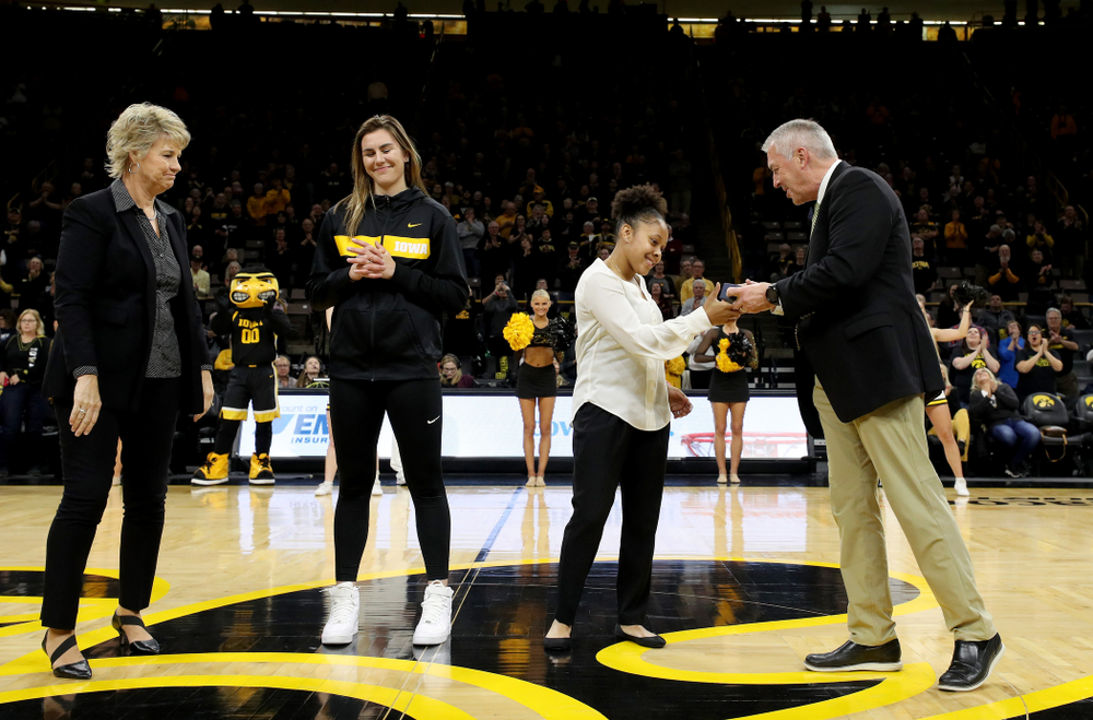 Former Hawkeye Tania Davis receives her Big Ten Tournament championship ring from Henry B. and Patricia B. Tippie Director of Athletics Chair Gary Barta before the Iowa Hawkeyes game against Clemson Wednesday, December 4, 2019 at Carver-Hawkeye Arena. (Brian Ray/hawkeyesports.com)