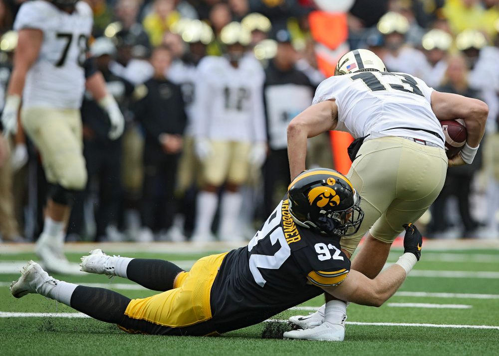 Iowa Hawkeyes defensive lineman John Waggoner (92) sacks Purdue Boilermakers quarterback Jack Plummer (13) during the second quarter of their game at Kinnick Stadium in Iowa City on Saturday, Oct 19, 2019. (Stephen Mally/hawkeyesports.com)