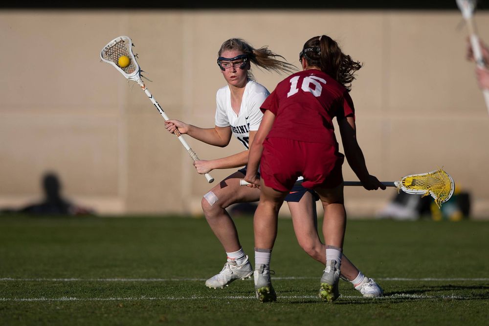 STANFORD, California - FEBRUARY 14: Virginia Cavaliers midfield Annie Dyson (19) is defended by Stanford Cardinal midfield Chelsea Trattner (16) during the second half at Cagan Stadium on February 14, 2020 in Stanford, California. The Virginia Cavaliers defeated the Stanford Cardinal 12-11. (Photo by Jason O. Watson)