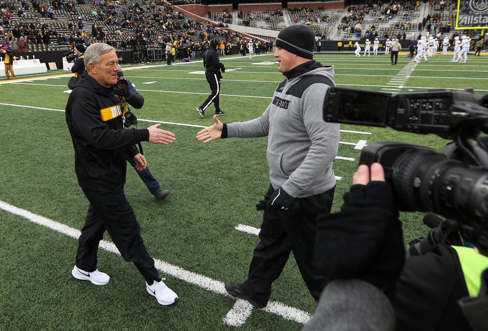 Iowa Hawkeyes head coach Kirk Ferentz shakes hands with Northwestern Wildcats head coach Pat Fitzgerald before a game against Northwestern at Kinnick Stadium on November 10, 2018. (Tork Mason/hawkeyesports.com)