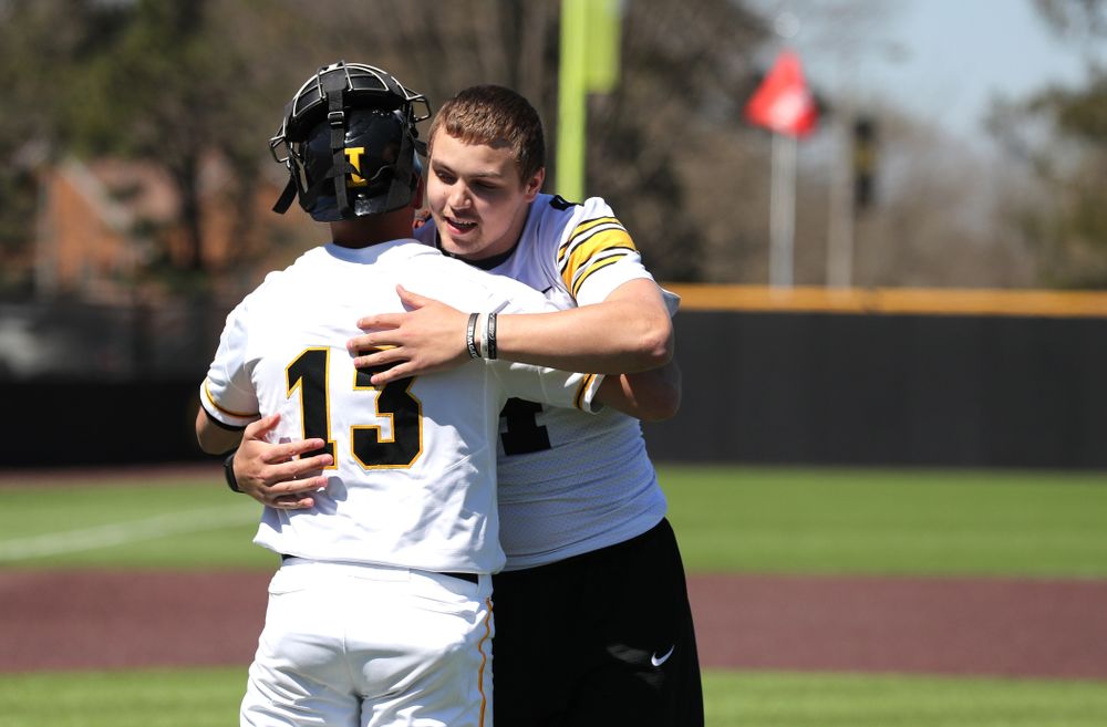 Iowa Hawkeyes quarterback Nate Stanley (4) throws out a first pitch against the Nebraska Cornhuskers Saturday, April 20, 2019 at Duane Banks Field. (Brian Ray/hawkeyesports.com)