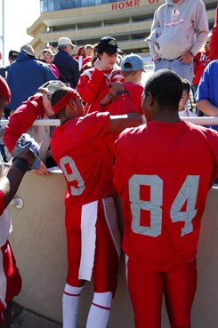 WRs Michael Scarlett and Ty Kirk sign autographs for fans after the game.