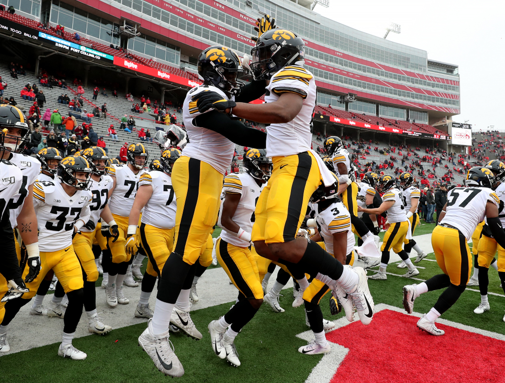 Iowa Hawkeyes running back Tyler Goodson (15) and defensive tackle Daviyon Nixon (54) against the Nebraska Cornhuskers Friday, November 29, 2019 at Memorial Stadium in Lincoln, Neb. (Brian Ray/hawkeyesports.com)