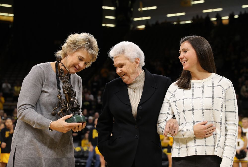 Former University of Iowa Director of Intercollegiate Athletics for Women Dr. Christine Grant receives her trophy for being inducted into the WomenÕs Basketball Hall of Fame from Iowa Hawkeyes head coach Lisa Bluder and director of basketball operations Kathryn Reynolds
before their game against the Robert Morris Colonials Sunday, December 2, 2018 at Carver-Hawkeye Arena. (Photo by Brian Ray)