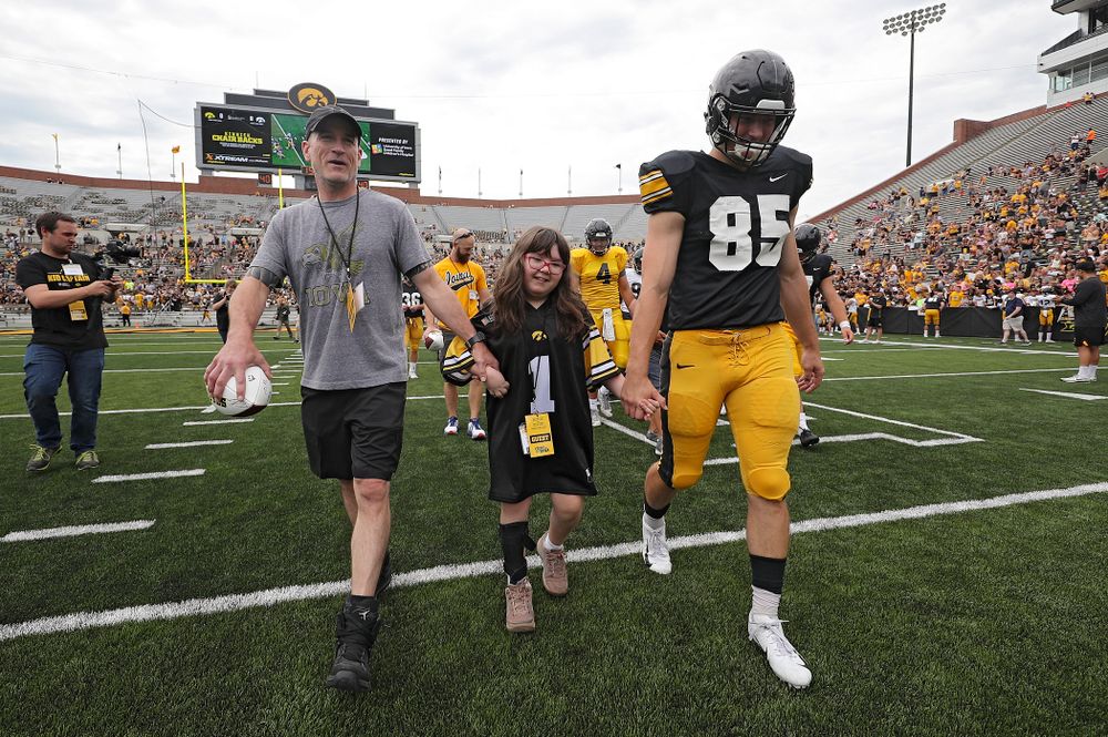 Kid Captain Lucy Roth swarms with Iowa Hawkeyes long snapper Nate Vejvoda (85) during Kids Day at Kinnick Stadium in Iowa City on Saturday, Aug 10, 2019. (Stephen Mally/hawkeyesports.com)