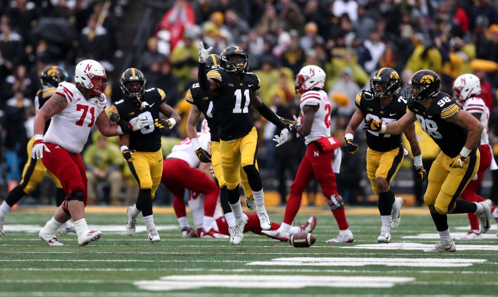 Iowa Hawkeyes defensive back Michael Ojemudia (11) celebrates after intercepting a pass against the Nebraska Cornhuskers Friday, November 23, 2018 at Kinnick Stadium. (Brian Ray/hawkeyesports.com)