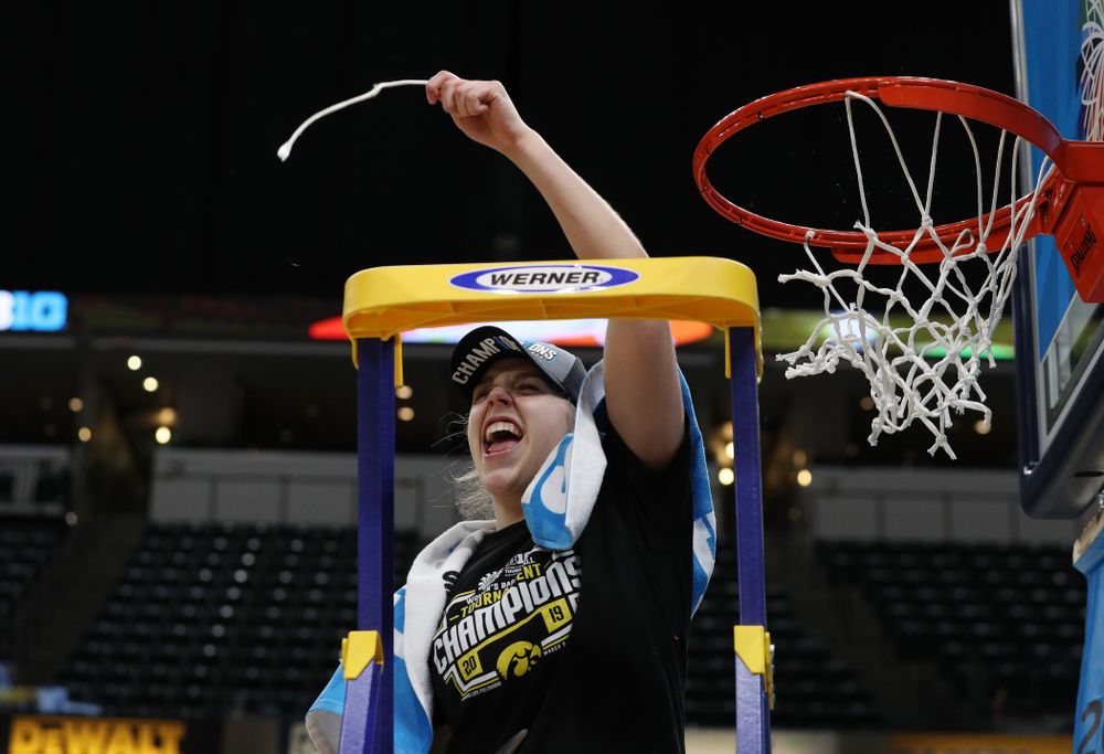 Iowa Hawkeyes guard Kathleen Doyle (22) cuts down the net as they celebrate their victory over the Maryland Terrapins in the Big Ten Championship Game Sunday, March 10, 2019 at Bankers Life Fieldhouse in Indianapolis, Ind. (Brian Ray/hawkeyesports.com)