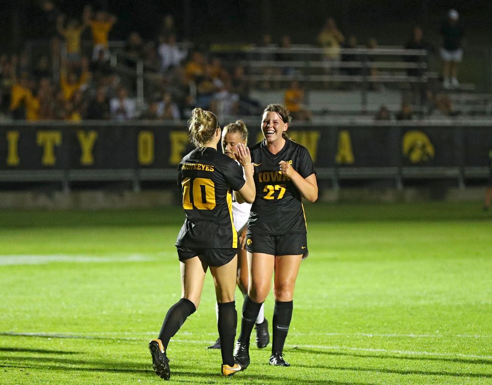 Iowa midfielder/defender Natalie Winters (10) celebrates with forward Samantha Tawharu (27) after Winters scored a goal on a penalty kick during the second half of their match against Western Michigan at the Iowa Soccer Complex in Iowa City on Thursday, Aug 22, 2019. (Stephen Mally/hawkeyesports.com)