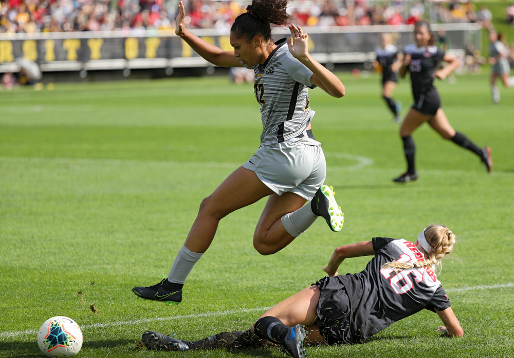 Iowa forward Olivia Fiegel (12) hurdles a defender during the first half of their match at the Iowa Soccer Complex in Iowa City on Sunday, Sep 1, 2019. (Stephen Mally/hawkeyesports.com)