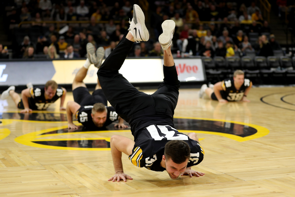 Members of the Hawkeye Football team performs with the Iowa Dance Team at halftime of the Iowa Hawkeyes game against the Ohio State Buckeyes Thursday, February 20, 2020 at Carver-Hawkeye Arena. (Brian Ray/hawkeyesports.com)