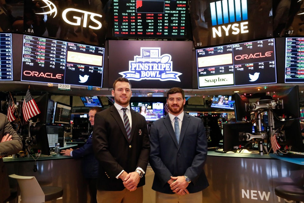 Iowa Hawkeyes linebacker Josey Jewell (43), defensive back Joshua Jackson (15), offensive lineman Sean Welsh (79) and head coach Kirk Ferentz ring the opening bell at the New York Stock Exchange Tuesday, December 26, 2017 in New York. (Brian Ray/hawkeyesports.com)