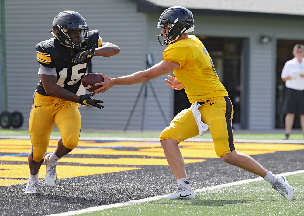Iowa Hawkeyes running back Tyler Goodson (15) takes a handoff from quarterback Peyton Mansell (2) during Fall Camp Practice No. 11 at the Hansen Football Performance Center in Iowa City on Wednesday, Aug 14, 2019. (Stephen Mally/hawkeyesports.com)