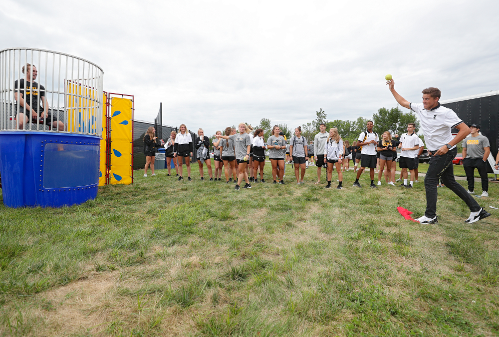 Iowa Men’s Tennis’ Joe Tyler throws to sink Women’s Tennis program coordinator Daniel Leitner in the dunk tank during the Student-Athlete Kickoff outside the Karro Athletics Hall of Fame Building in Iowa City on Sunday, Aug 25, 2019. (Stephen Mally/hawkeyesports.com)