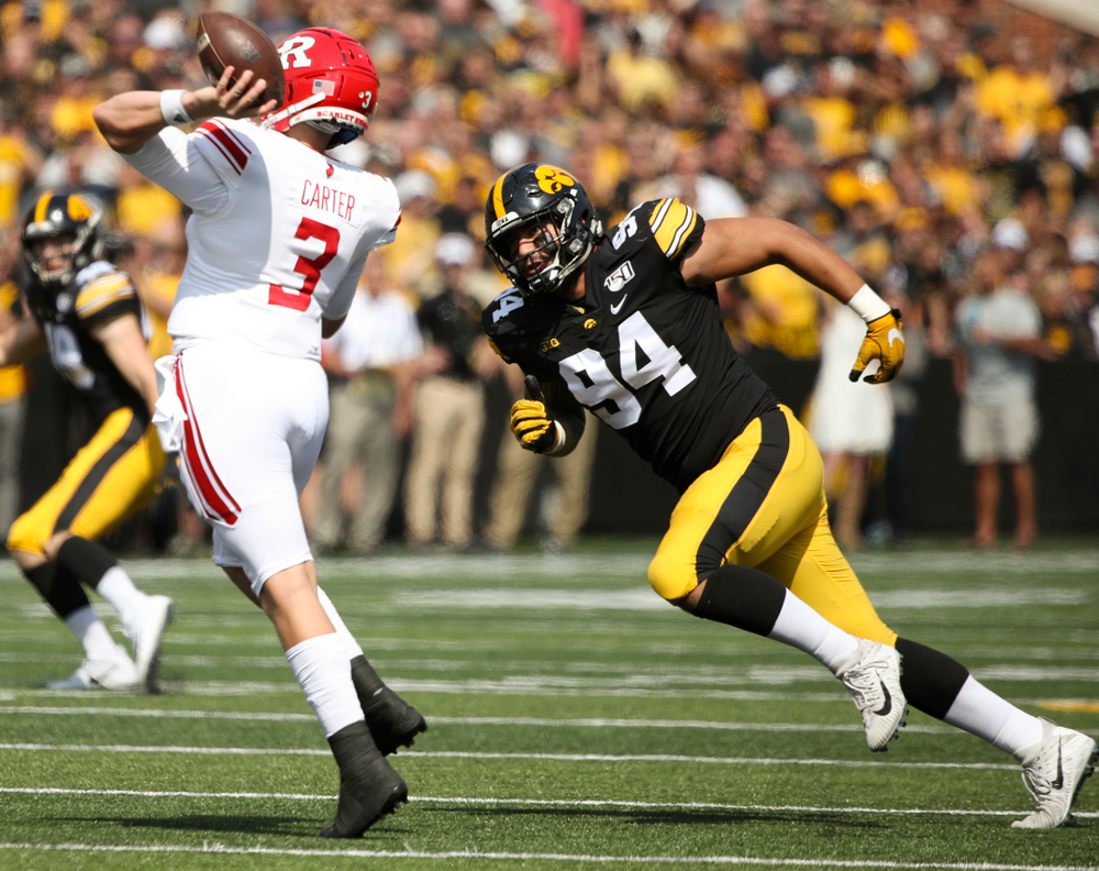 Iowa Hawkeyes defensive end A.J. Epenesa (94) chases Rutgers quarterback McLane Carter (3) during the first quarter of their Big Ten Conference football game at Kinnick Stadium in Iowa City on Saturday, Sep 7, 2019. (Stephen Mally/hawkeyesports.com)