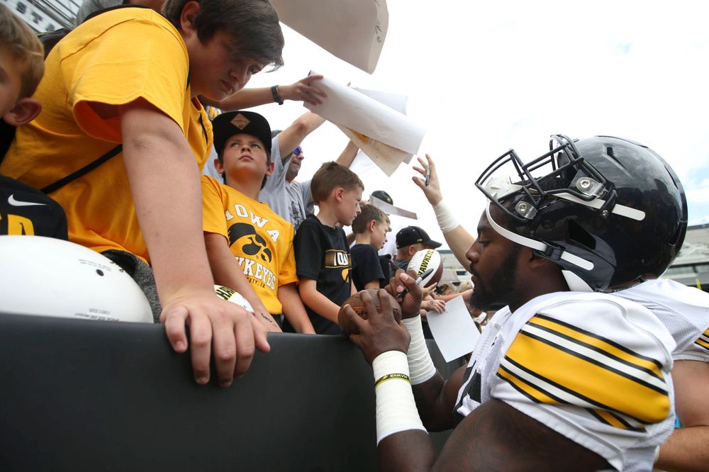 Iowa Hawkeyes linebacker Amani Jones (52) signs autographs during Kids Day at Kinnick Stadium on Saturday, August 10, 2019. (Lily Smith/hawkeyesports.com)