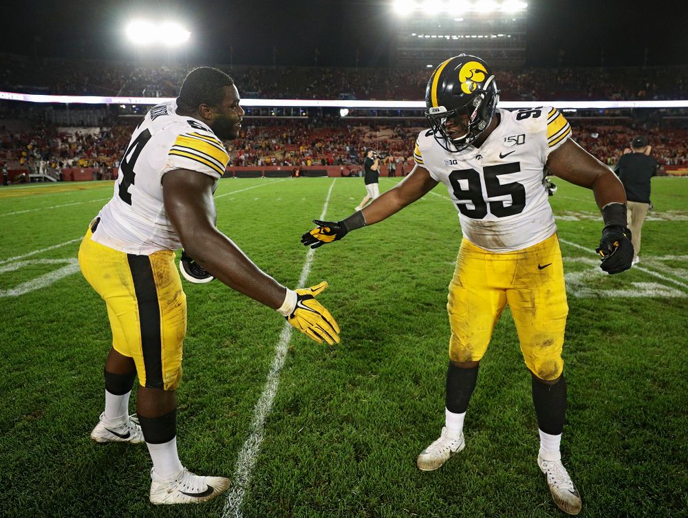 Iowa Hawkeyes defensive tackle Daviyon Nixon (54) and defensive lineman Cedrick Lattimore (95) celebrate after winning their Iowa Corn Cy-Hawk Series game at Jack Trice Stadium in Ames on Saturday, Sep 14, 2019. (Stephen Mally/hawkeyesports.com)