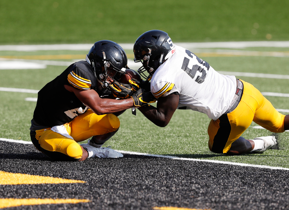 Iowa Hawkeyes running back Ivory Kelly-Martin (21) and linebacker Amani Jones (52) during camp practice No. 17 Wednesday, August 22, 2018 at the Kenyon Football Practice Facility. (Brian Ray/hawkeyesports.com)