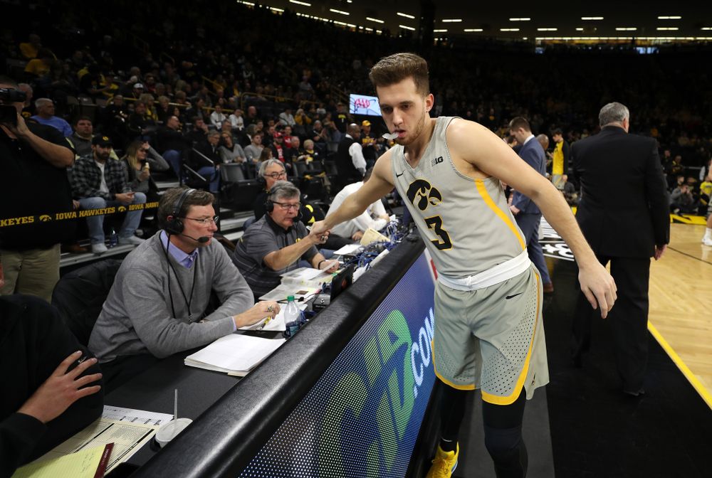Iowa Hawkeyes guard Jordan Bohannon (3) fist bumps radio announcer Gary Dolphin before their game against the Nebraska Cornhuskers Sunday, January 6, 2019 at Carver-Hawkeye Arena. (Brian Ray/hawkeyesports.com)