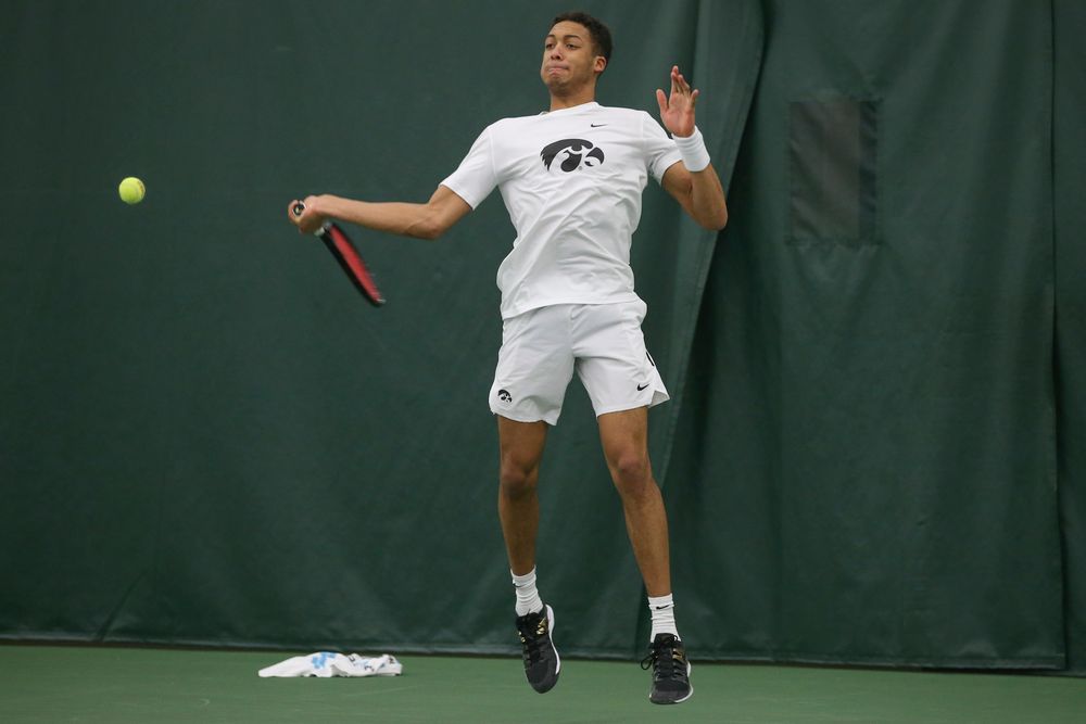 Iowa’s Oliver Okonkwo returns a hit during the Iowa men’s tennis meet vs Nebraska on Sunday, March 1, 2020 at the Hawkeye Tennis and Recreation Complex. (Lily Smith/hawkeyesports.com)