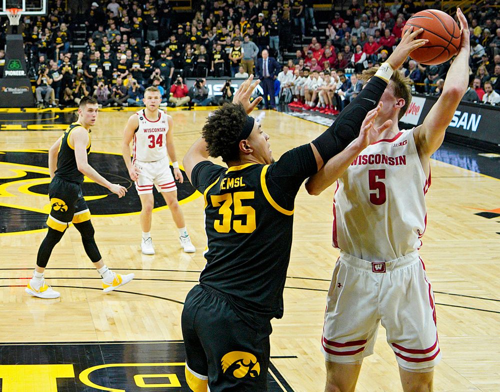 Iowa Hawkeyes forward Cordell Pemsl (35) blocks a shot by Wisconsin Badgers forward Tyler Wahl (5) during the first half of their game at Carver-Hawkeye Arena in Iowa City on Monday, January 27, 2020. (Stephen Mally/hawkeyesports.com)