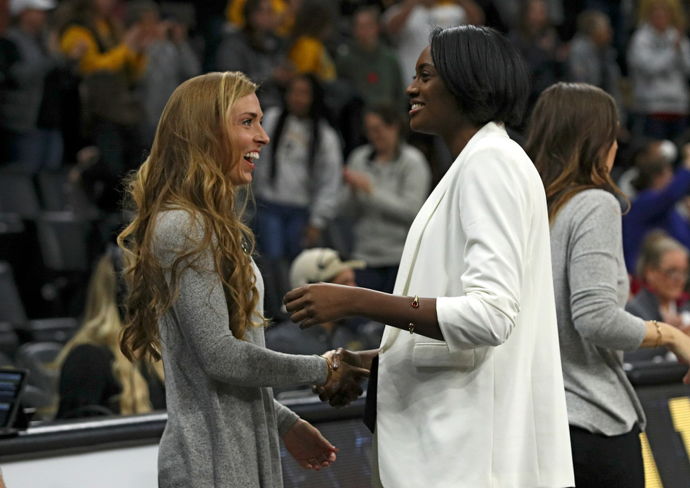 Iowa director of operations Emily Sparks (from left) shakes hands with head coach Vicki Brown after winning their match at Carver-Hawkeye Arena in Iowa City on Saturday, Nov 30, 2019. (Stephen Mally/hawkeyesports.com)