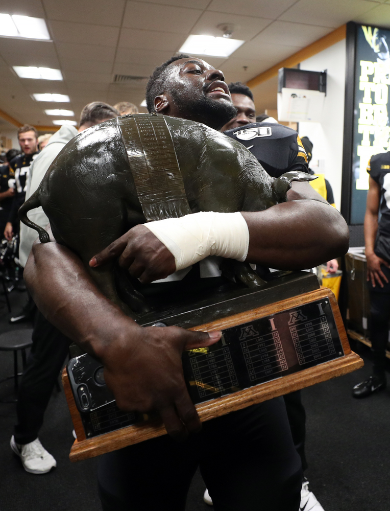 Iowa Hawkeyes linebacker Amani Jones (52) holds the Floyd of Rosedale Trophy following their win against the Minnesota Golden Gophers Saturday, November 16, 2019 at Kinnick Stadium. (Brian Ray/hawkeyesports.com)
