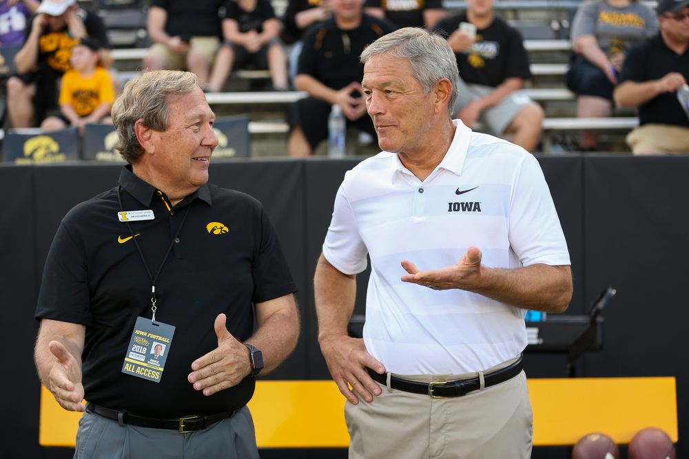 University of Iowa President Bruce Harreld and Iowa Hawkeyes head coach Kirk Ferentz talk before a game against Northern Iowa at Kinnick Stadium on September 15, 2018. (Tork Mason/hawkeyesports.com)